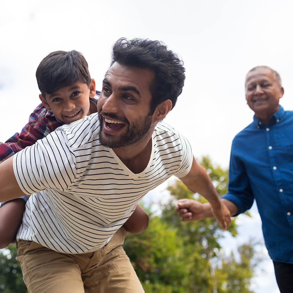 father and son playing with grandfather watching the fun