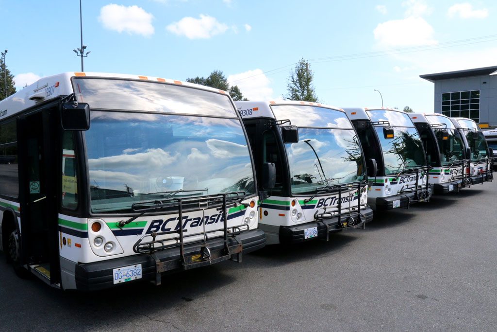 a row of parked BC Transit buses