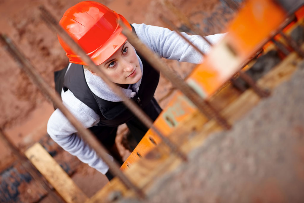 a worker in a hardhat climbing a ladder