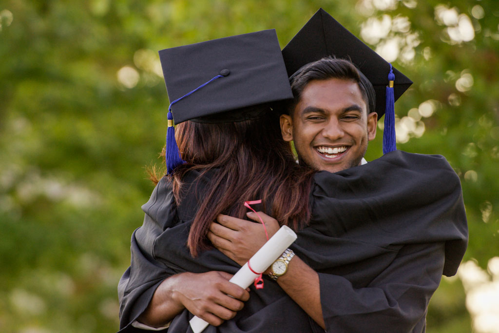 two graduates celebrating
