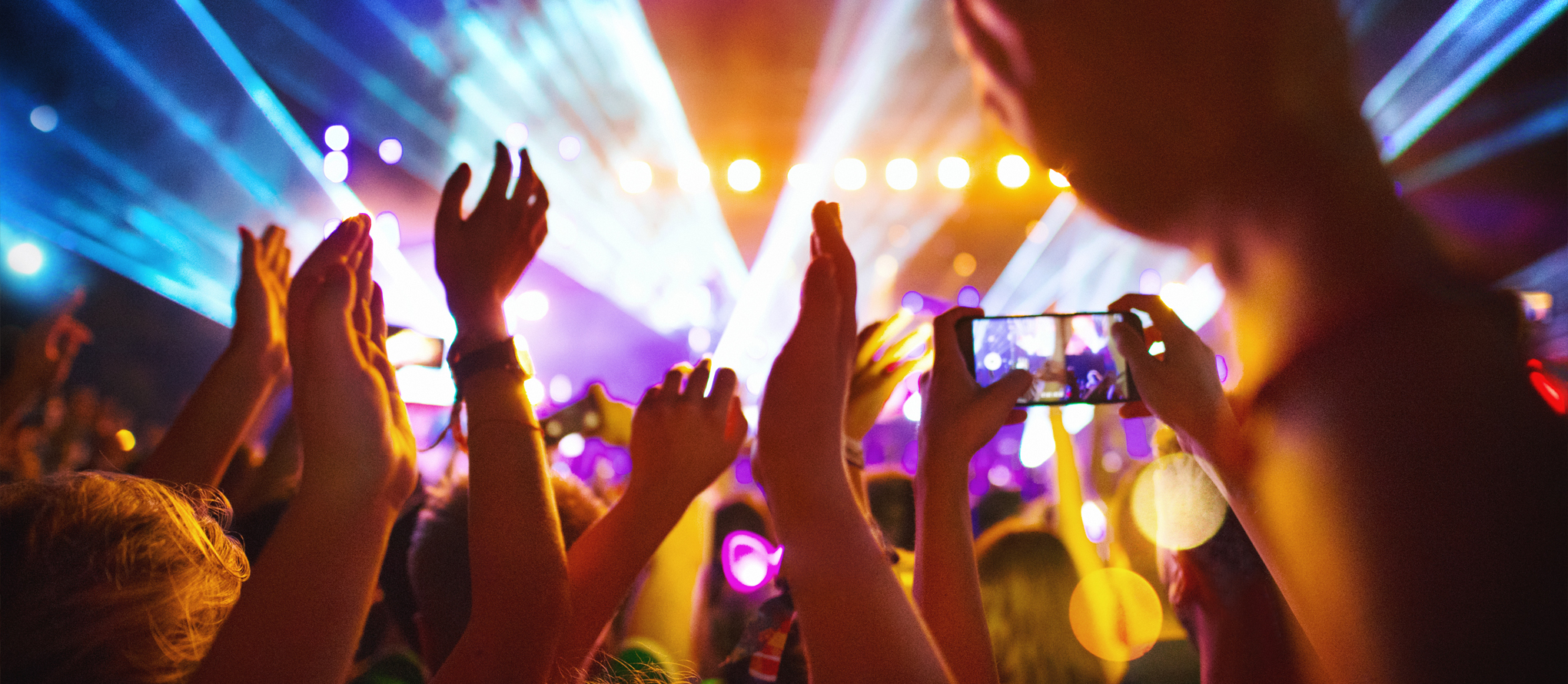 hands up holding phones at a rock concert
