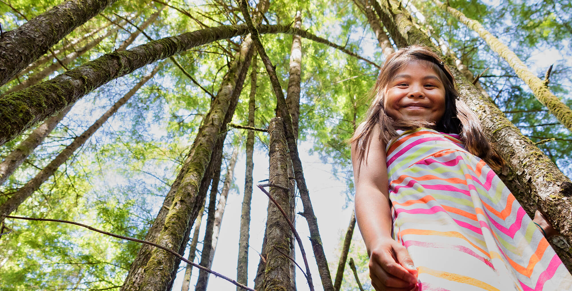 a young girl in the forest smiling