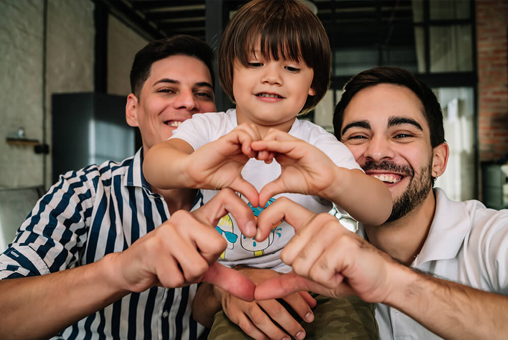a happy family making hearts with their hands