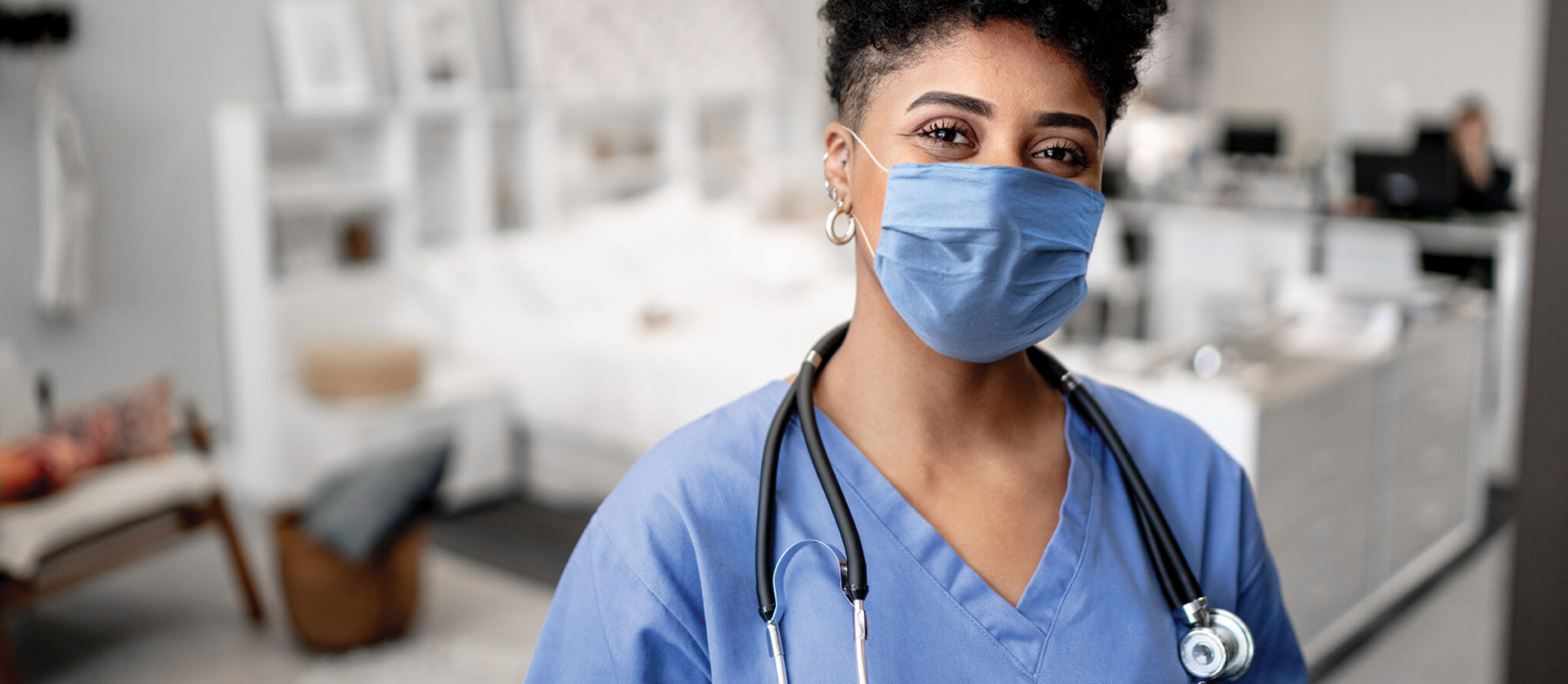 nurse in scrubs and a mask