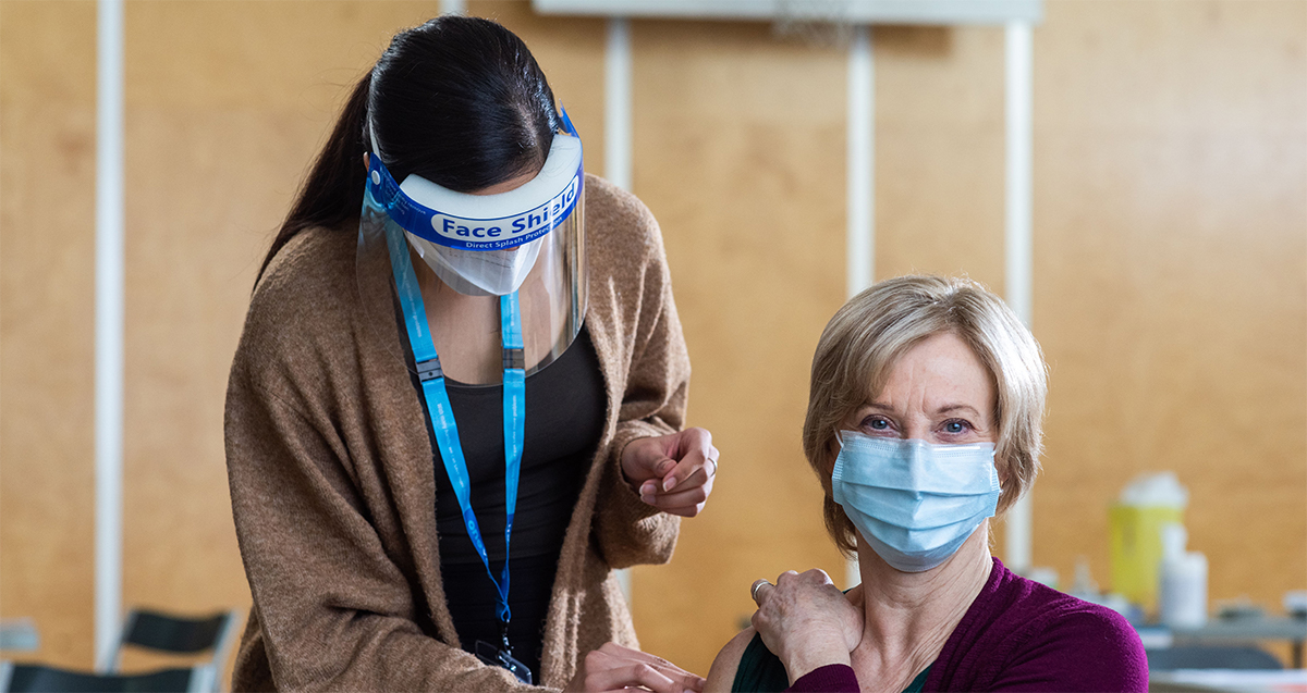 a picture of a person recieving a Covid shot