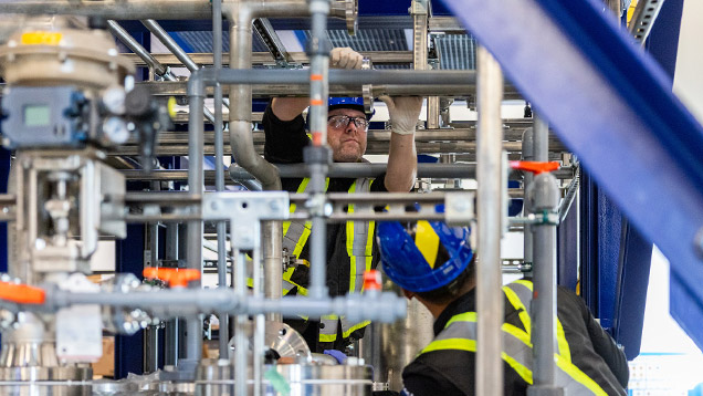 A worker in an industrial facility demonstrates skilled trades training on an innovative technology designed to safeguard for the future.